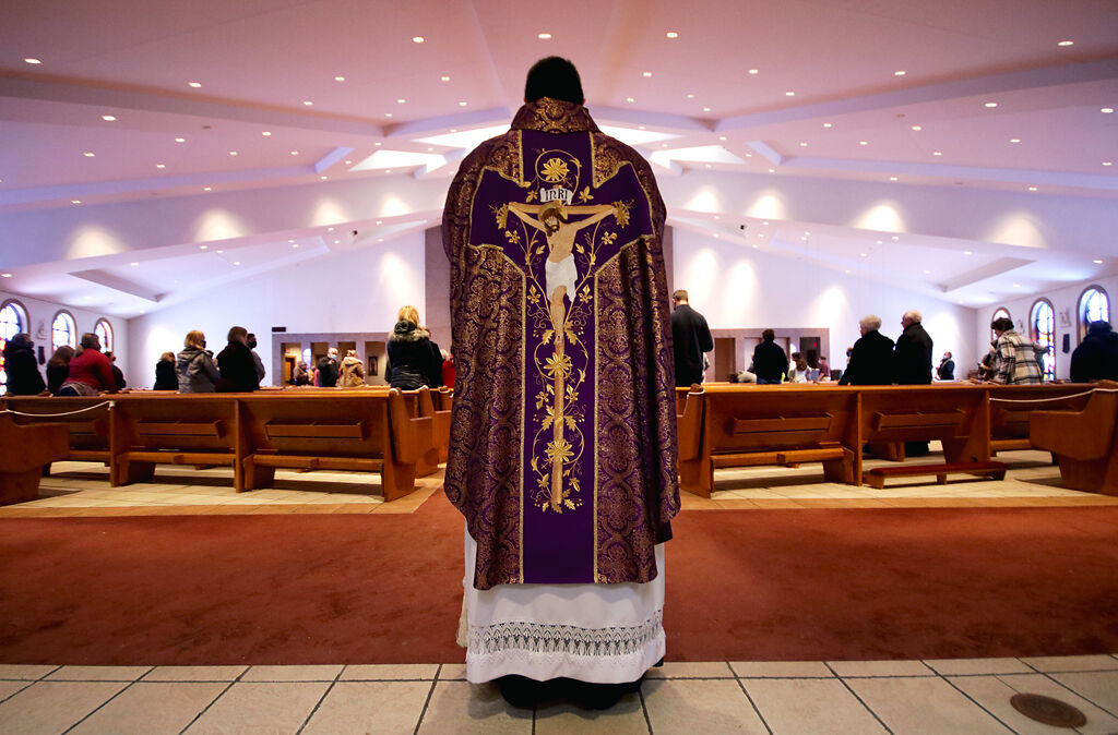 Fr. Aubuchon stands before the congregation